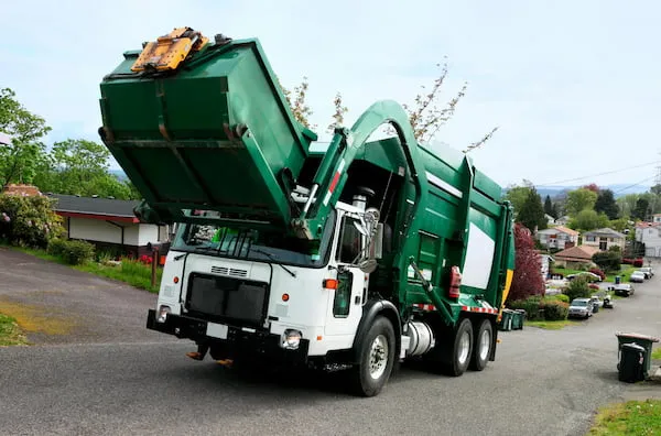 Image of commercial dumpster being serviced