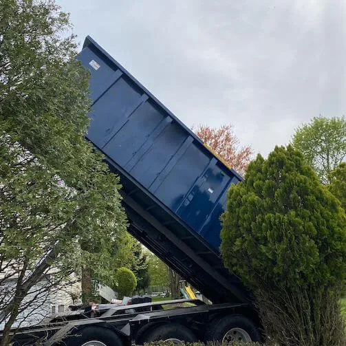 Large roll off bin being moved from truck