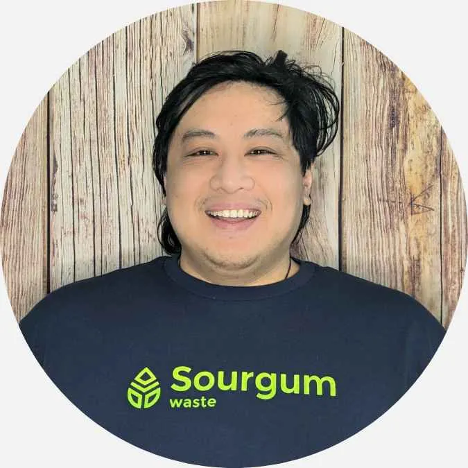 headshot of Shawn Louie on a wooden background