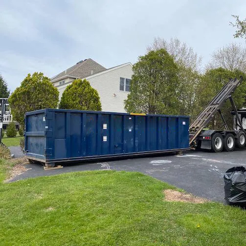Dumpster being delivered to a home location